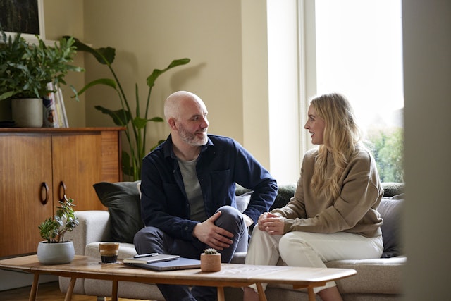 Mat and Michelle chatting on a sofa