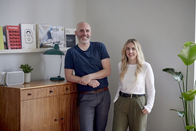 Mat and Michelle, standing by the bureaux and smiling.