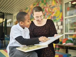 A child and a woman reading together