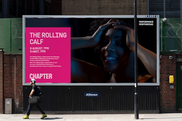 A mockup of a billboard for “The Rolling Calf” a performance event at Chapter. A man is walking past the billboard at the bottom left of the image.