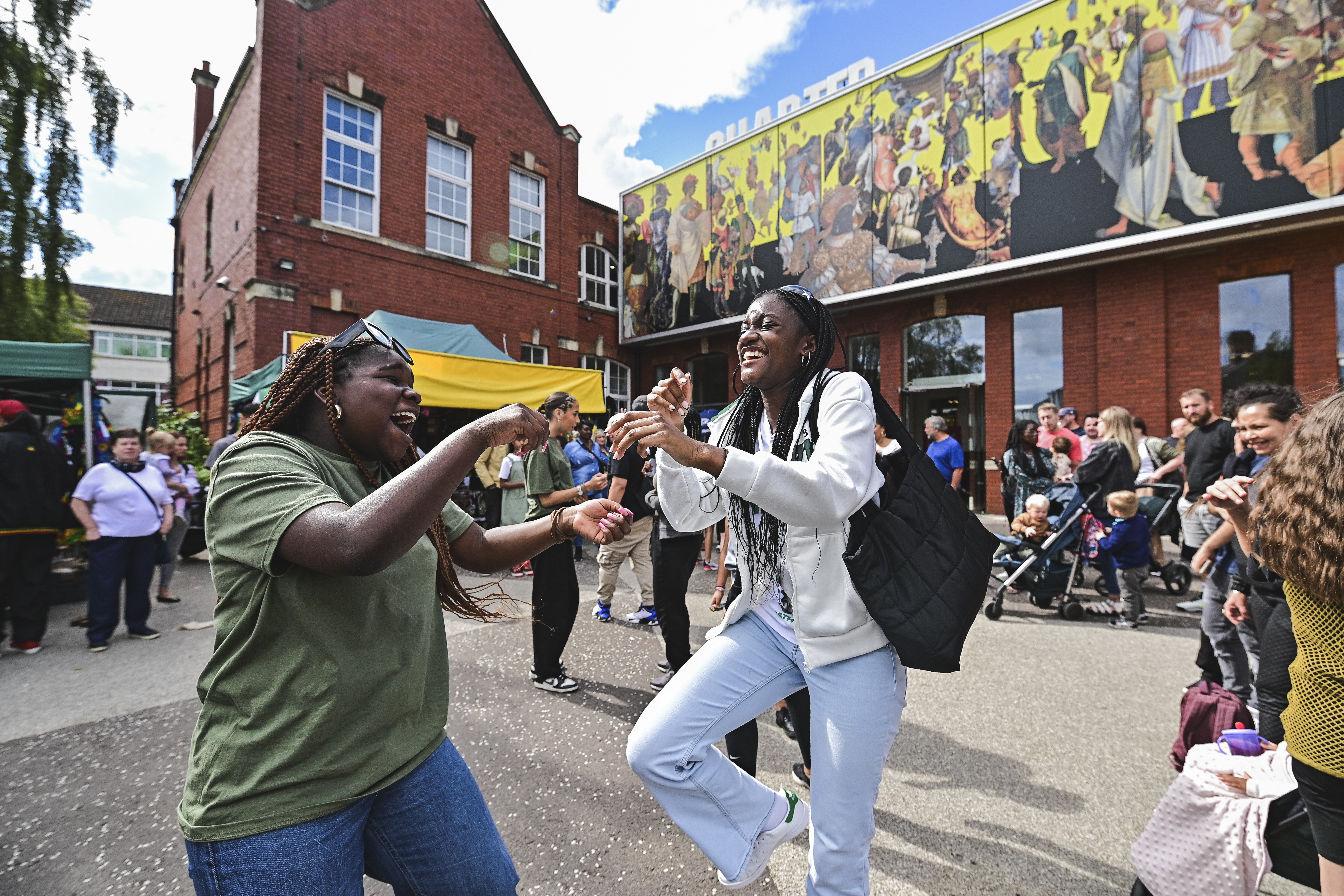 Two women dancing outside Chapter