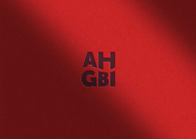 The AHGBI logo on a red background