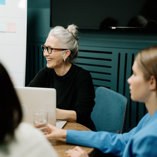 A woman smiling in a meeting