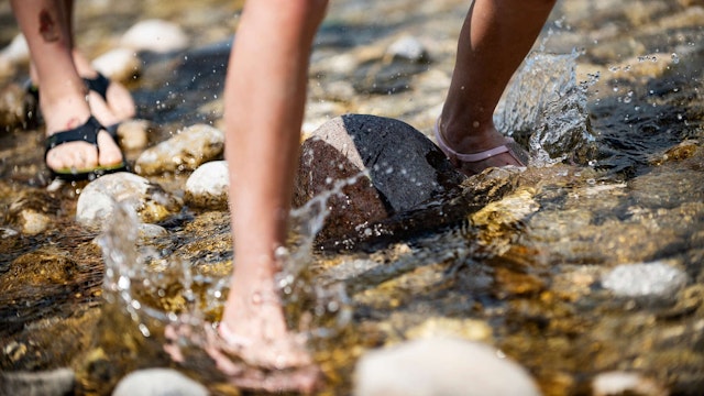 Feet in a shallow river stream