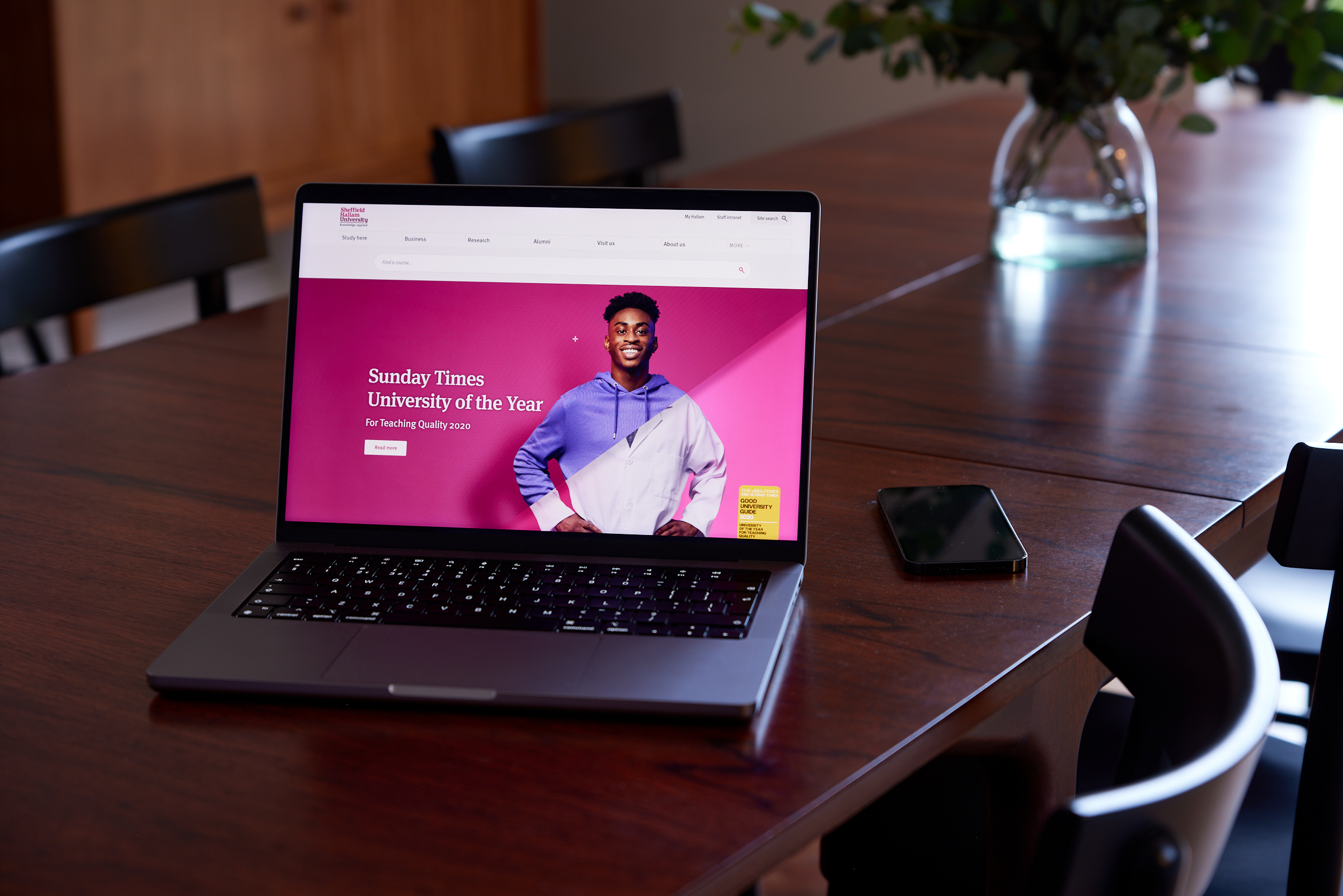 Sheffield Hallam University homepage on a laptop on a wooden table