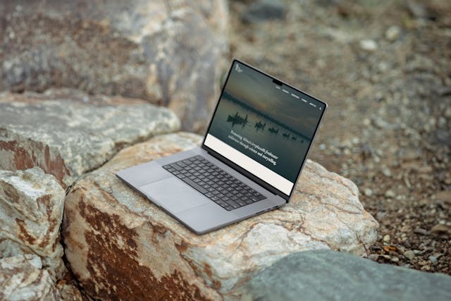 The Wilderness Project website shown on a laptop. The laptop is situated outdoors, on a rock