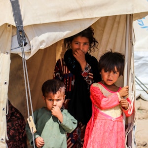Three child refugees in a tent Kabul