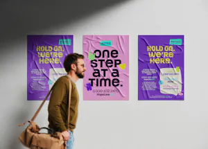 A man walking past 3 Papyrus posters